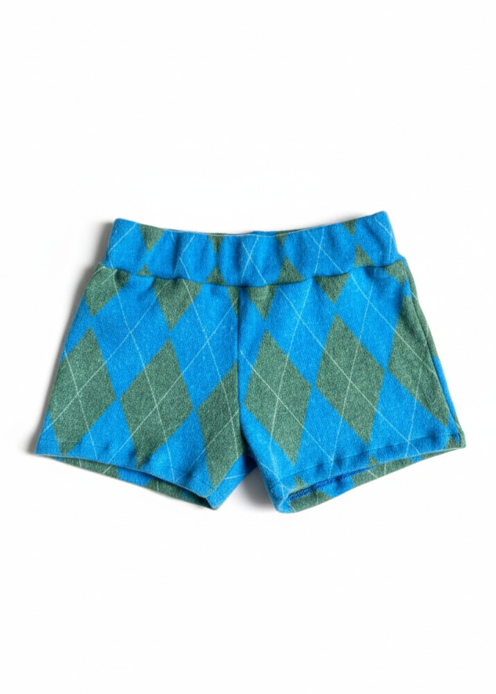 Short mini de tiro semi cadera confeccionado en tela aterciopelada licrada de alta calidad, que combina una textura suave y aterciopelada con la elasticidad necesaria para un ajuste cómodo y favorecedor. Su diseño realza la silueta con una caída limpia y un calce preciso.
